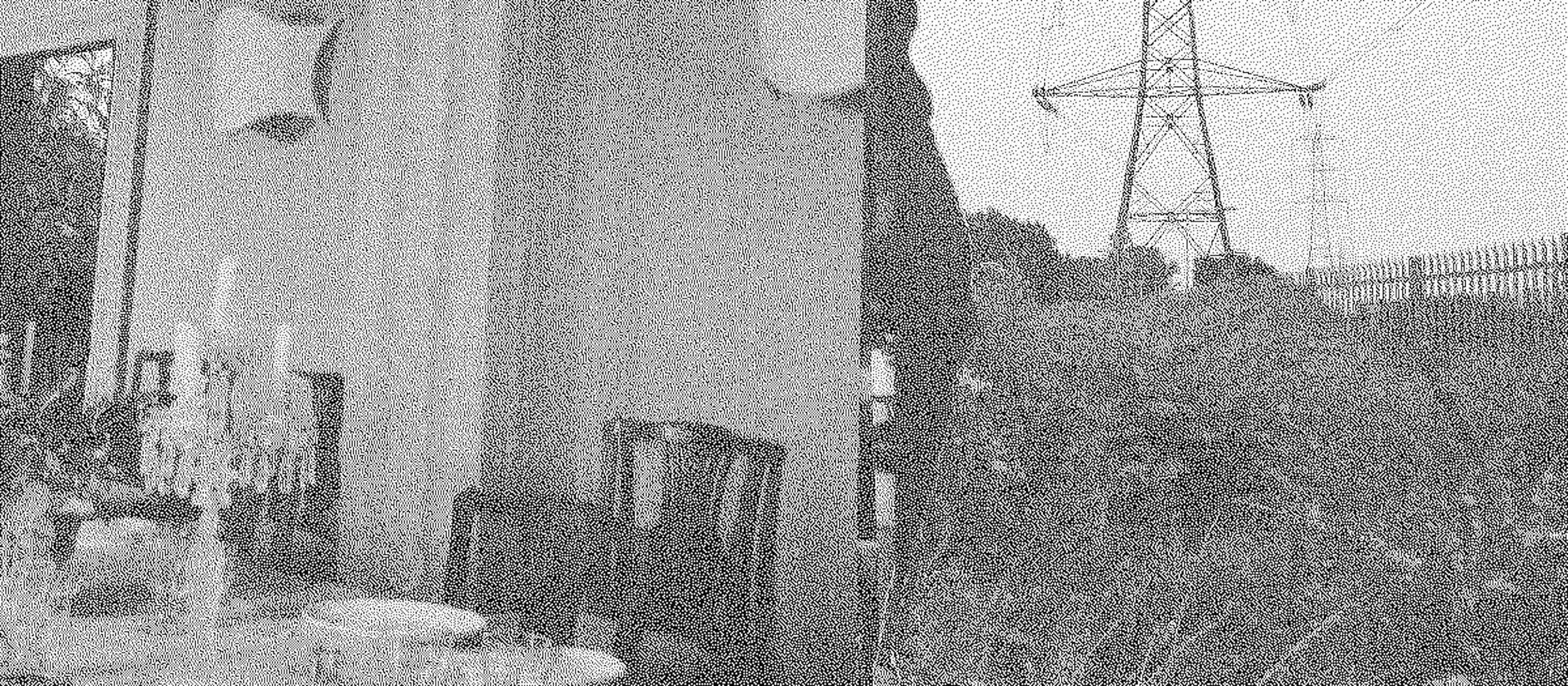 Black and white image. A couch, fireplace mantle, chairs, and an area rug are juxtaposed, perhaps collaged, against a landscape of trees and power lines.